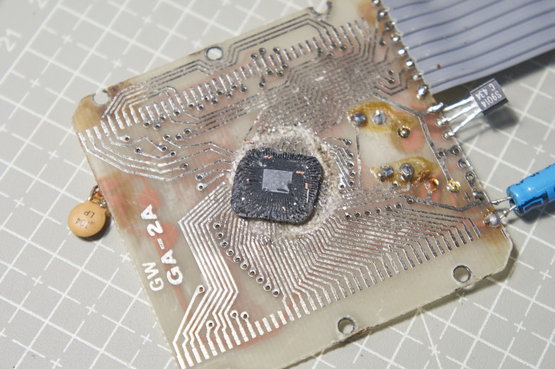 Underside of silicon die surrounded by compound